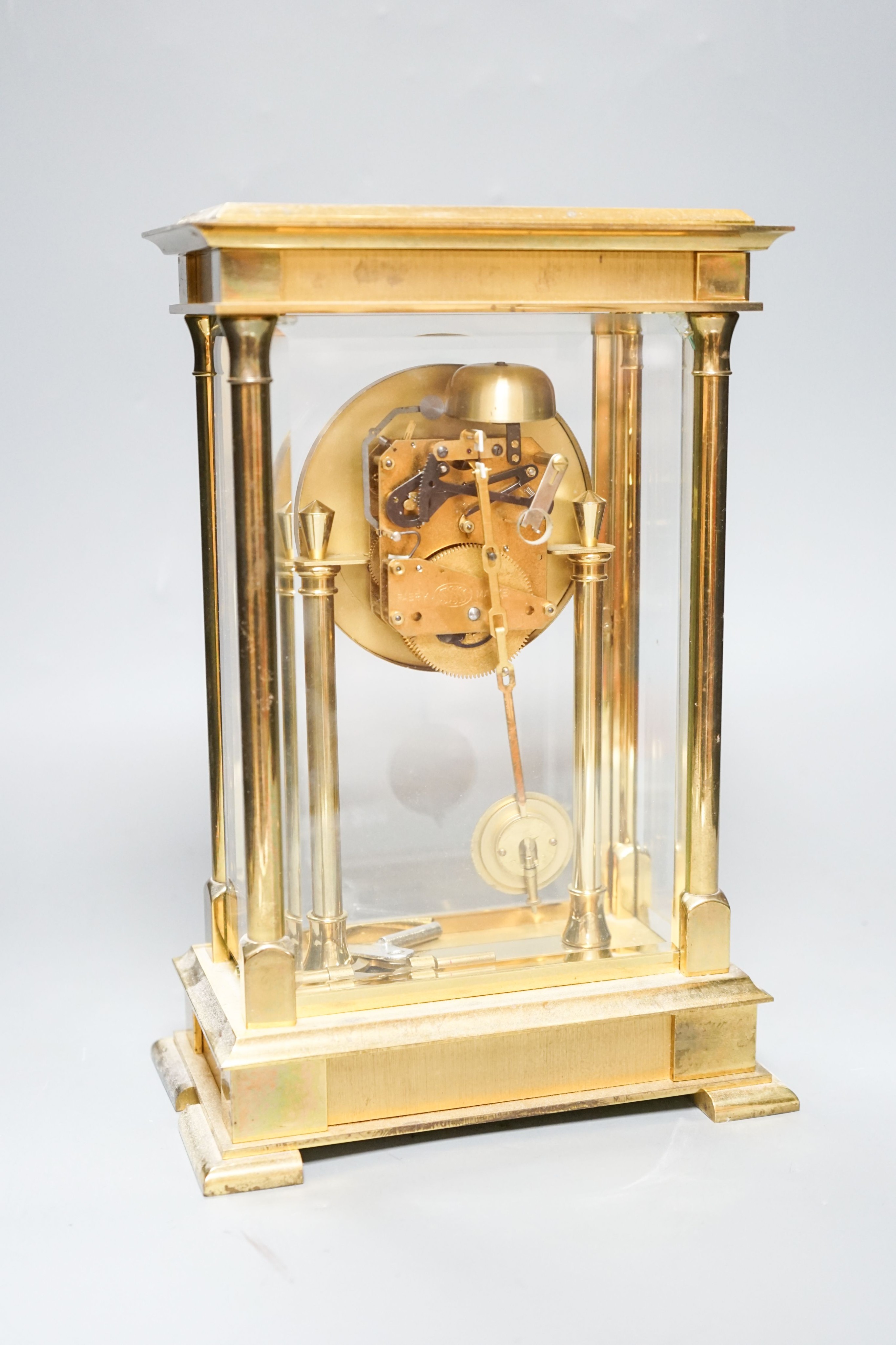 An 8 day brass cased clock 29cm